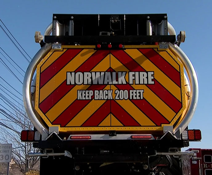 The Norwalk Fire Department's new blocker truck with the Scorpion attenuator in the stowed position displaying the reflective chevrons and warning label: "Keep Back 200 Feet".