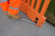 Lightly step down on the ADA Leg to release it from the notch