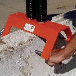The T-Pins on the TrafFix Barrier Buster are connected to hardened steel threaded holes to secure the stand to a concrete barrier wall.