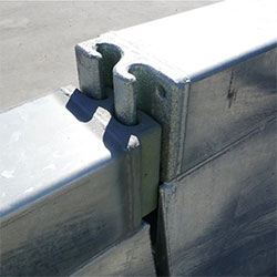 The HV2 Barrier's strong "S" connectors keep barrier sections securely linked and are being set in place.