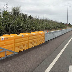 The HV2 Barrier with the SLED End Treatment in a construction zone along a roadway.