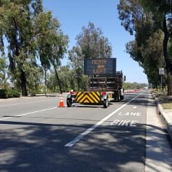 Scorpion II Towable Attenuator with attached Arrow Board protecting a work-zone.