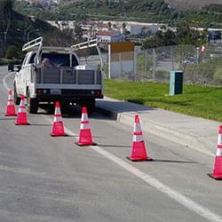 A system of 6 Quick Deploy Spring Cones being used along the side of the road, image #1.