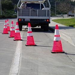 A system of 6 Quick Deploy Spring Cones being used along the side of the road, image #2.