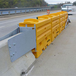 SLED (US) attached to a concrete median barrier.