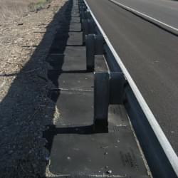 TrafFix Weed Mats installed along a highway.